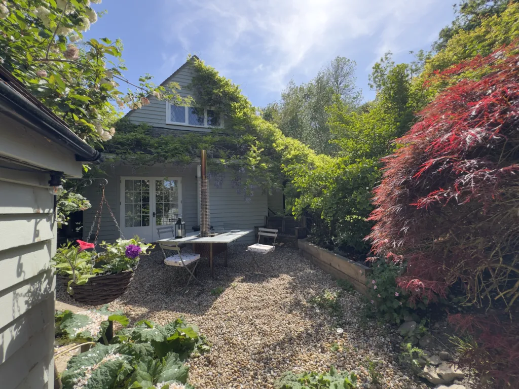 Little Strand and its gravel garden, with a bistro table and a Japanese maple